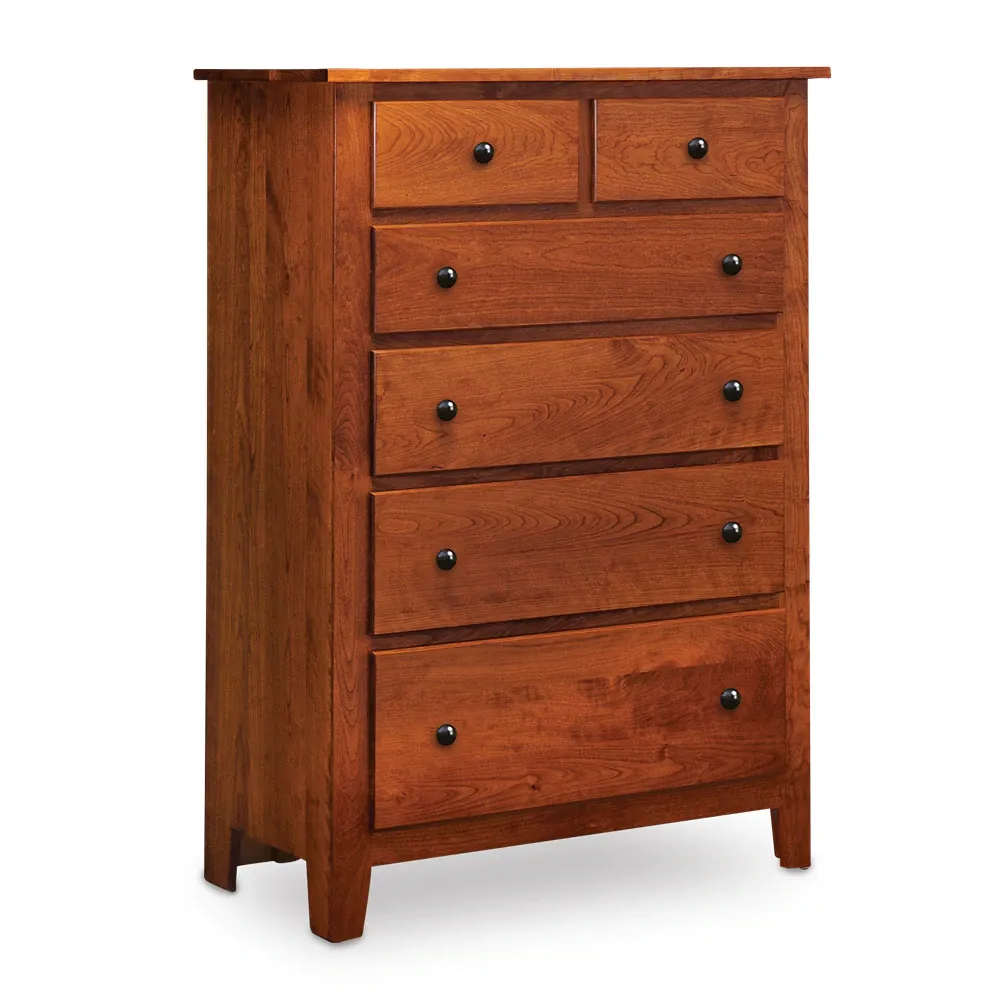 A wooden chest of drawers with black handles on a white background