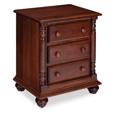 A wooden nightstand with three drawers on a white background