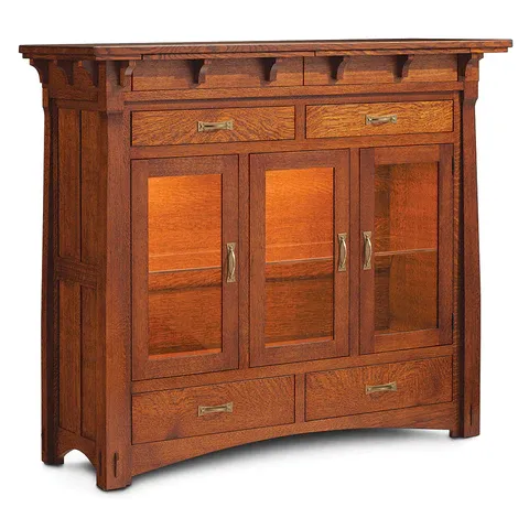 A wooden cabinet with glass doors and drawers