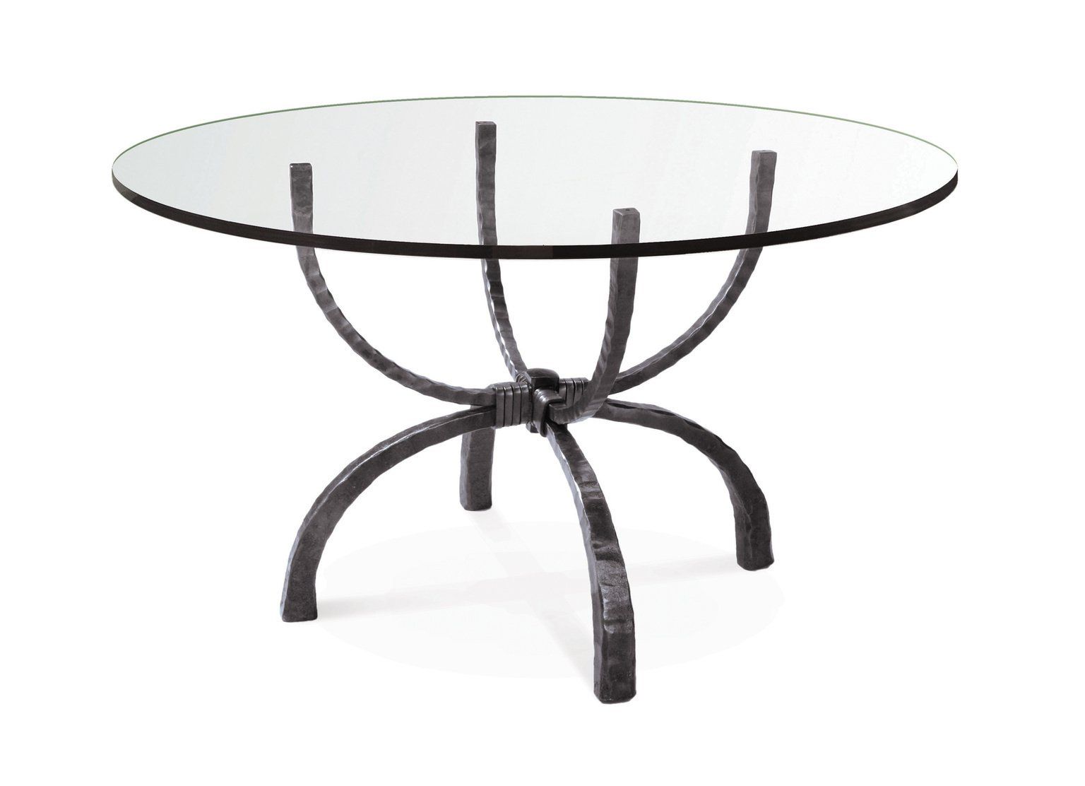 A round glass table with a wrought iron base on a white background