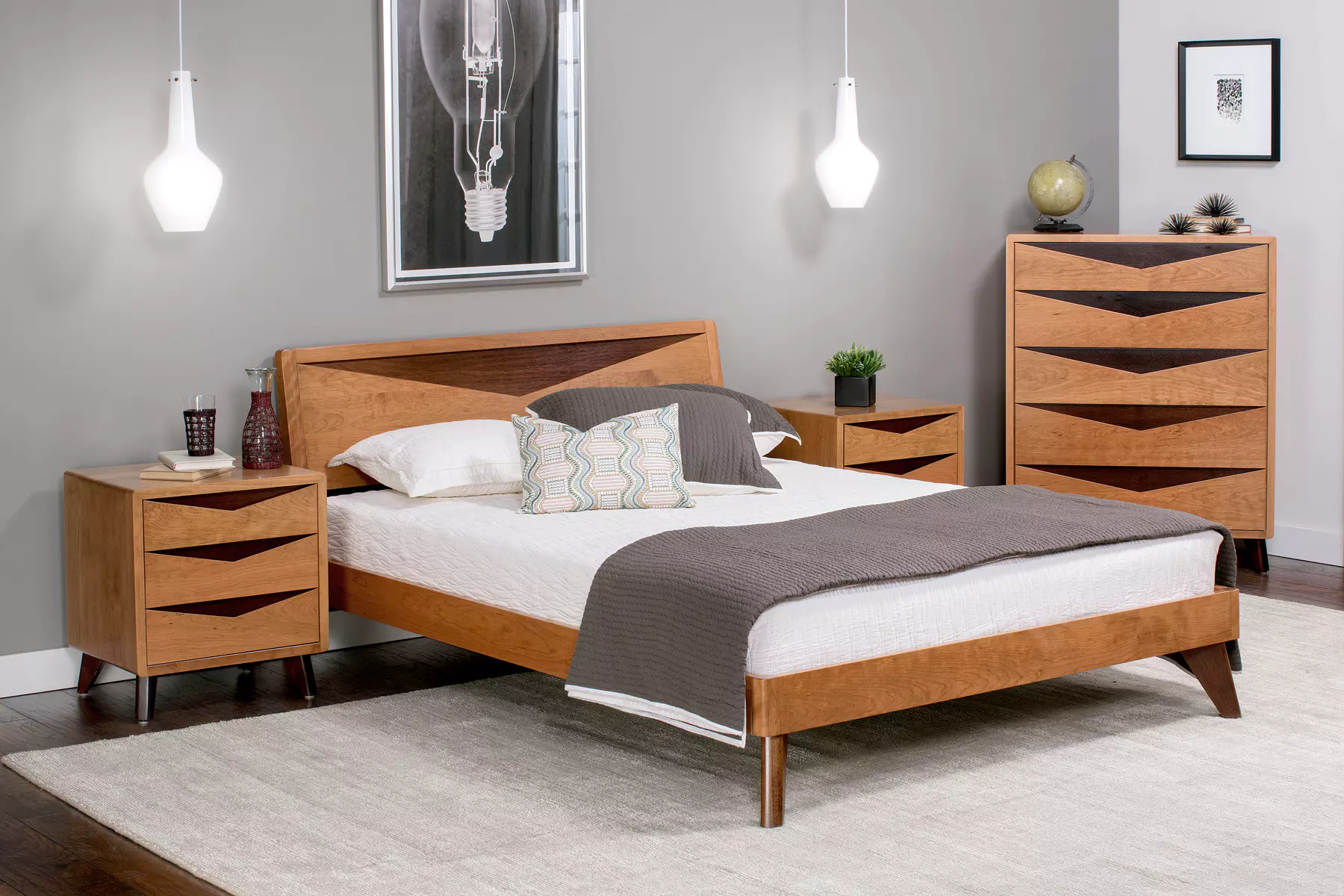 A bedroom with a bed , dresser and nightstands