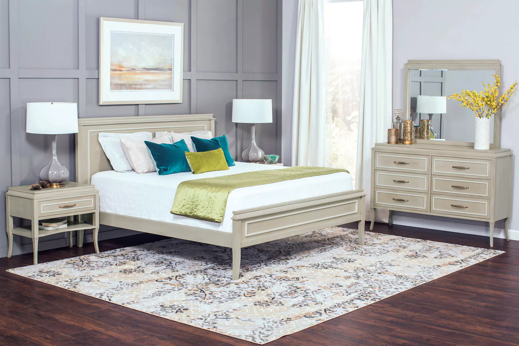 A bedroom with a bed , dresser , nightstand , mirror and rug.