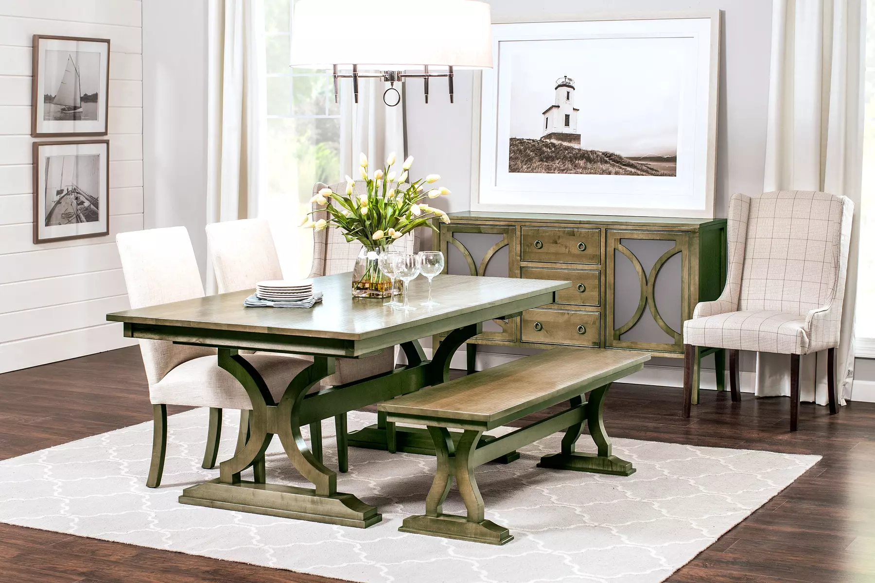 A dining room with a table and chairs and a bench.