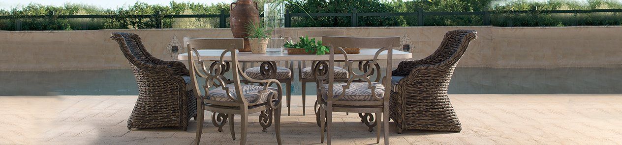 A table and chairs are sitting on a patio next to a pool.
