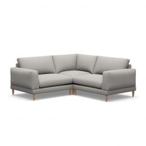 A grey sectional couch with wooden legs on a white background.