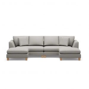 A grey sectional couch with wooden legs on a white background.