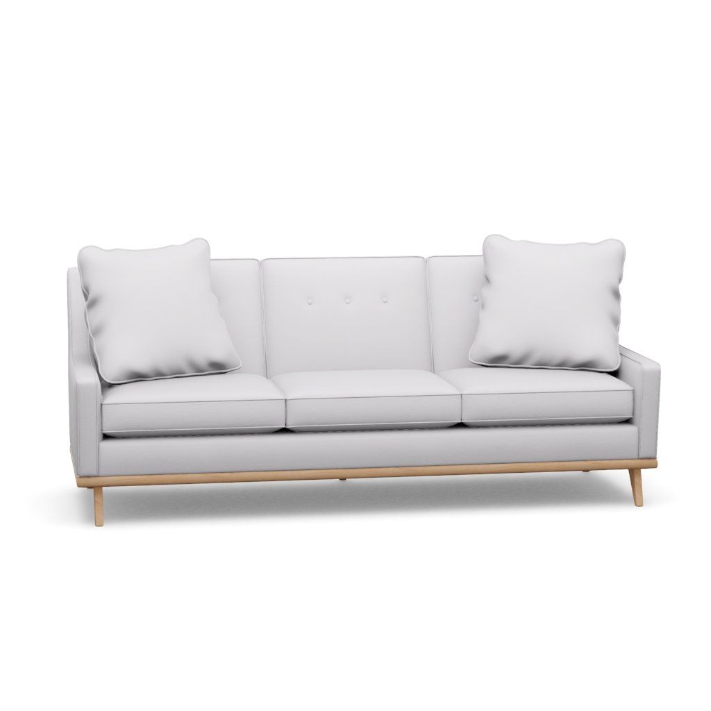 A white couch with wooden legs and pillows on a white background.