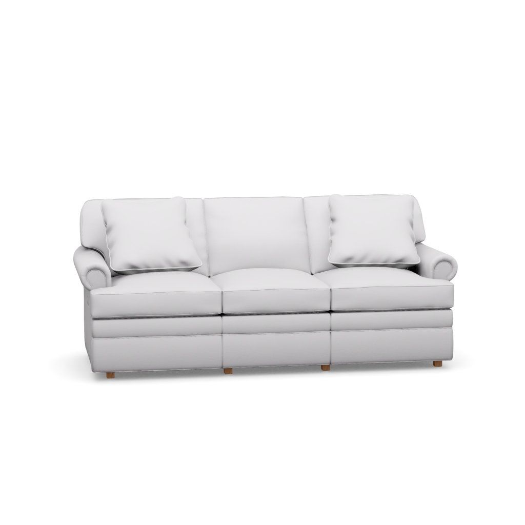 A white couch with three pillows on a white background.