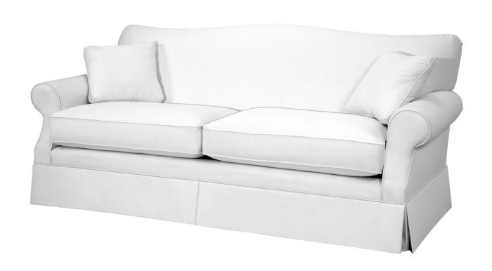 A white couch with two pillows on it