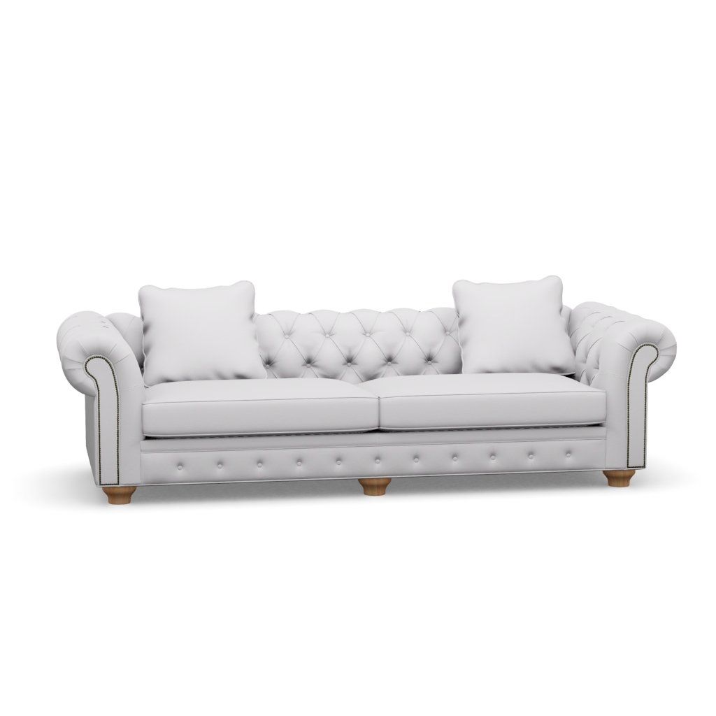 A white couch with pillows on a white background.