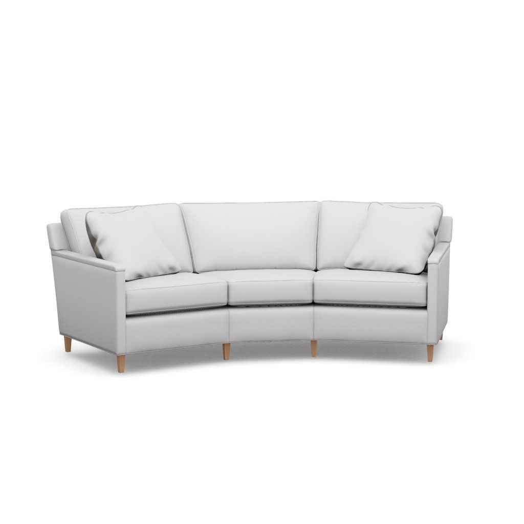 A white curved sectional couch with wooden legs on a white background.