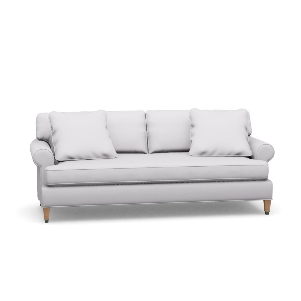 A white couch with three pillows on a white background.