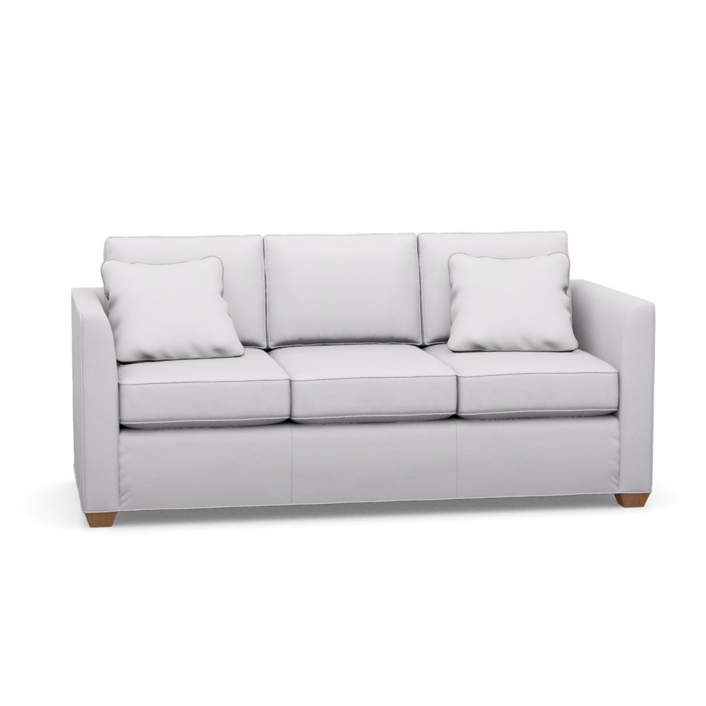 A white couch with three pillows on a white background.
