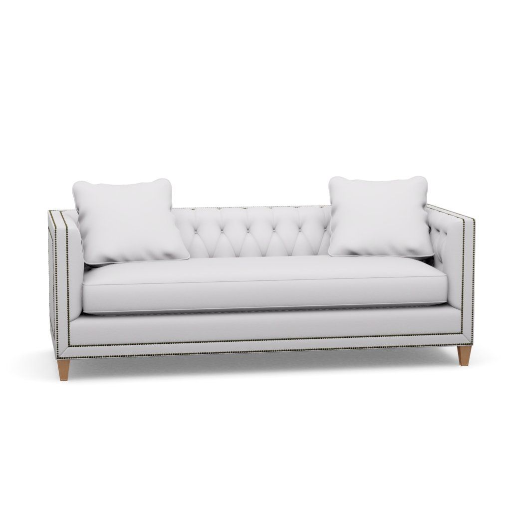 A white couch with two pillows on a white background.