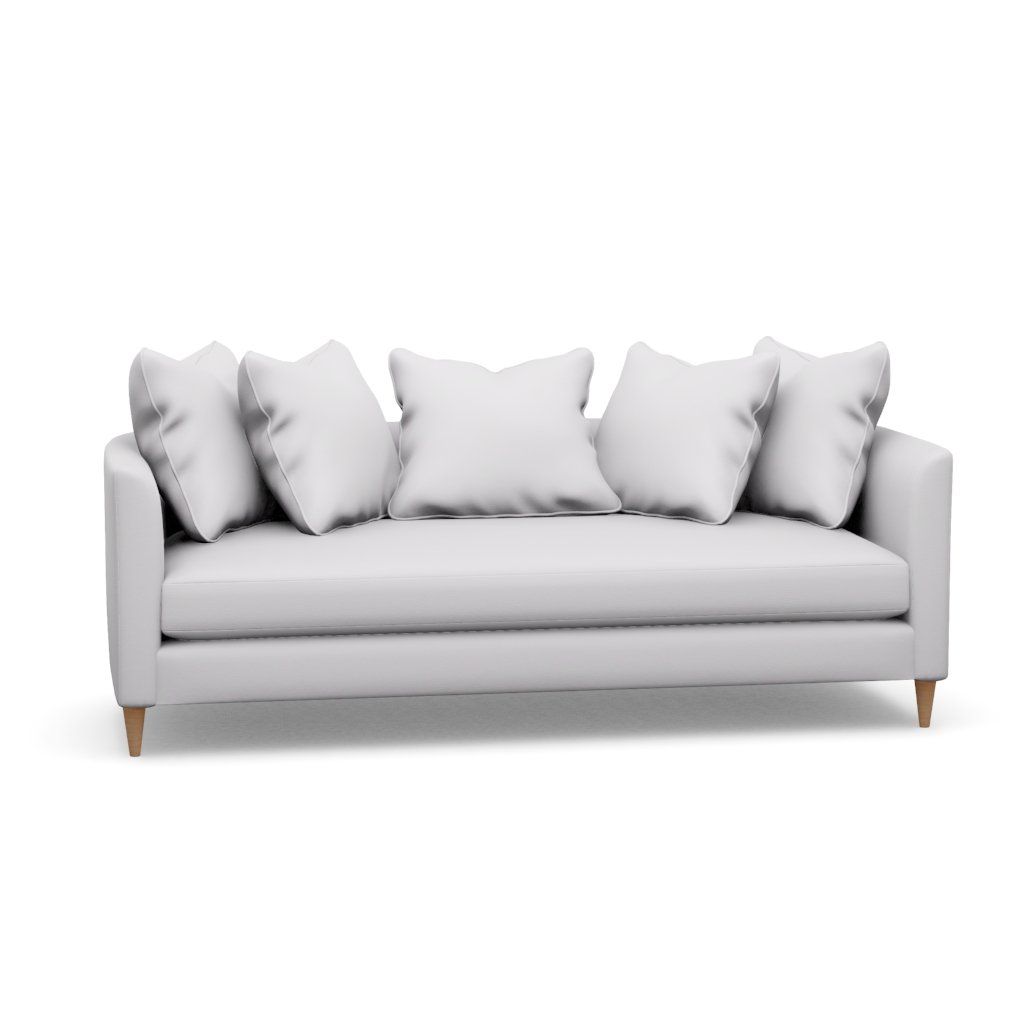 A white couch with white pillows on a white background.