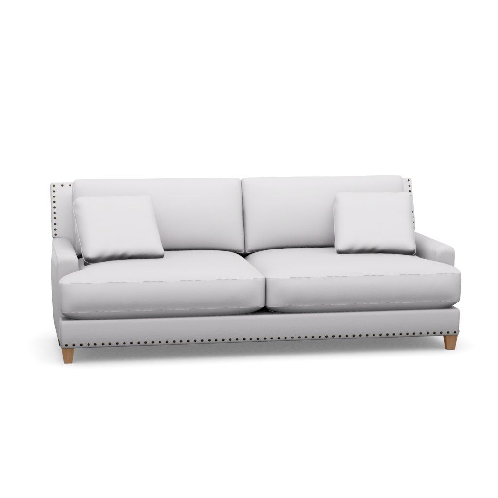 A white couch with two pillows on a white background.