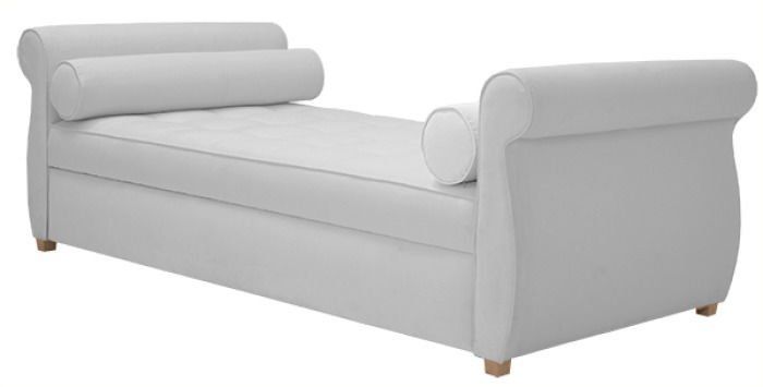 A white chaise lounge with two pillows on it on a white background.