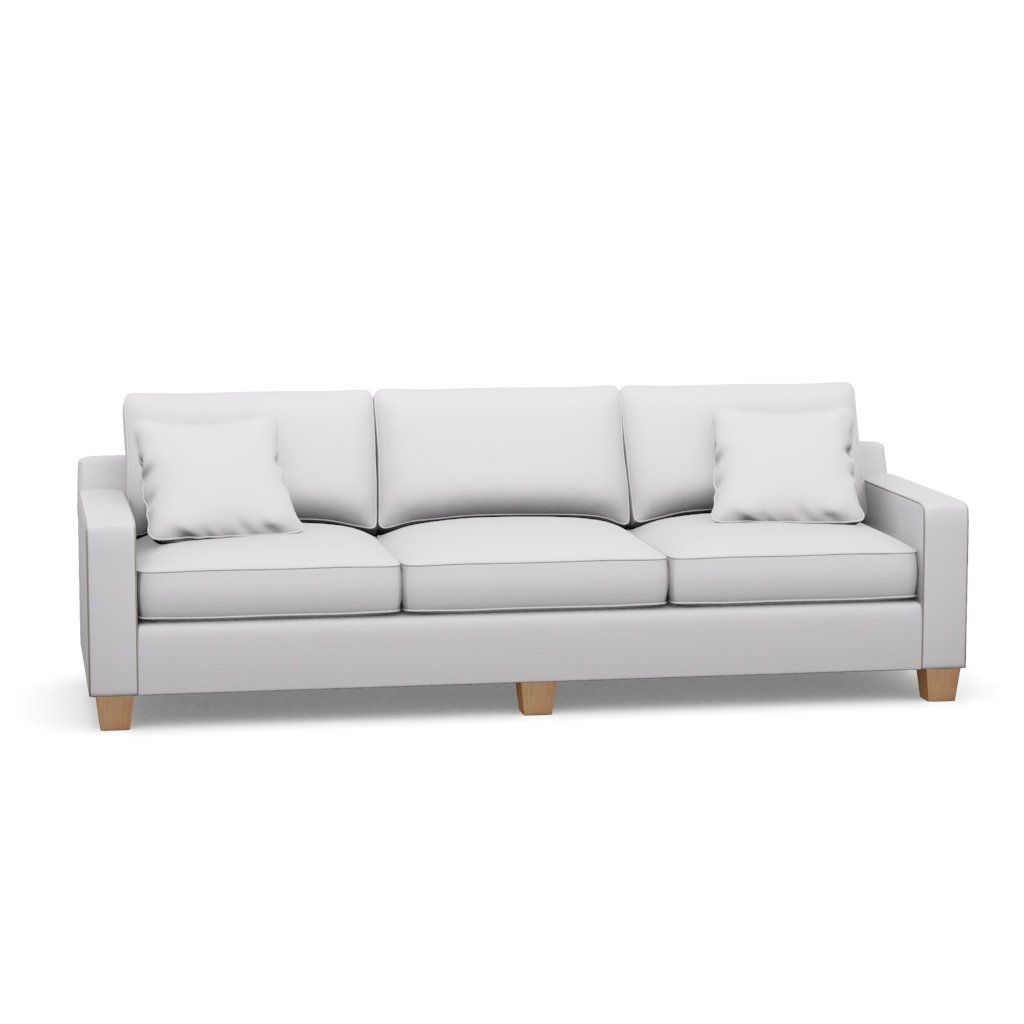 A white couch with wooden legs and pillows on a white background.