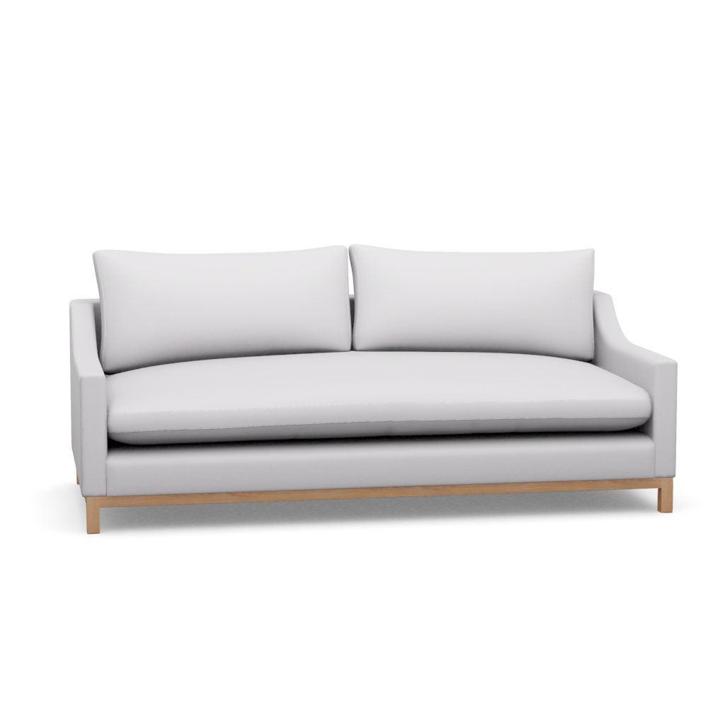 A white couch with wooden legs on a white background.