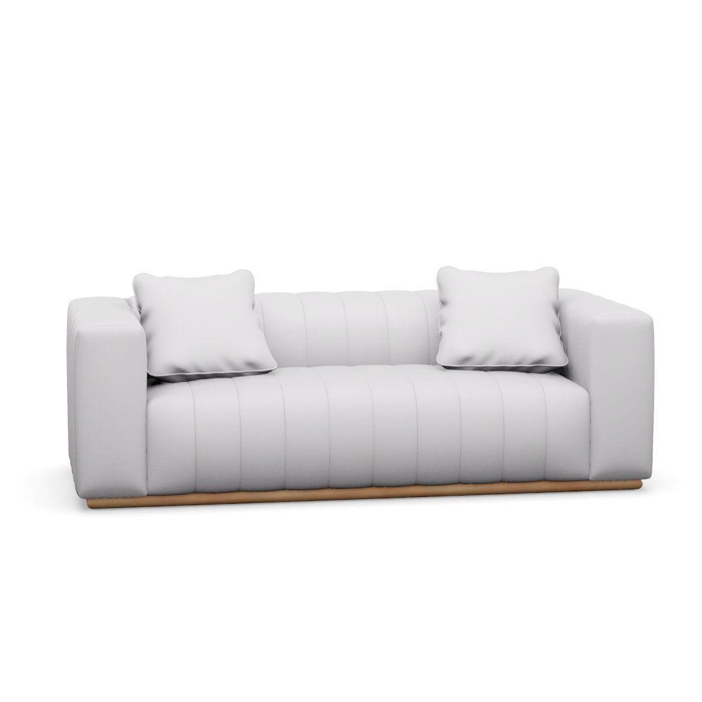 A white couch with two pillows on a white background.