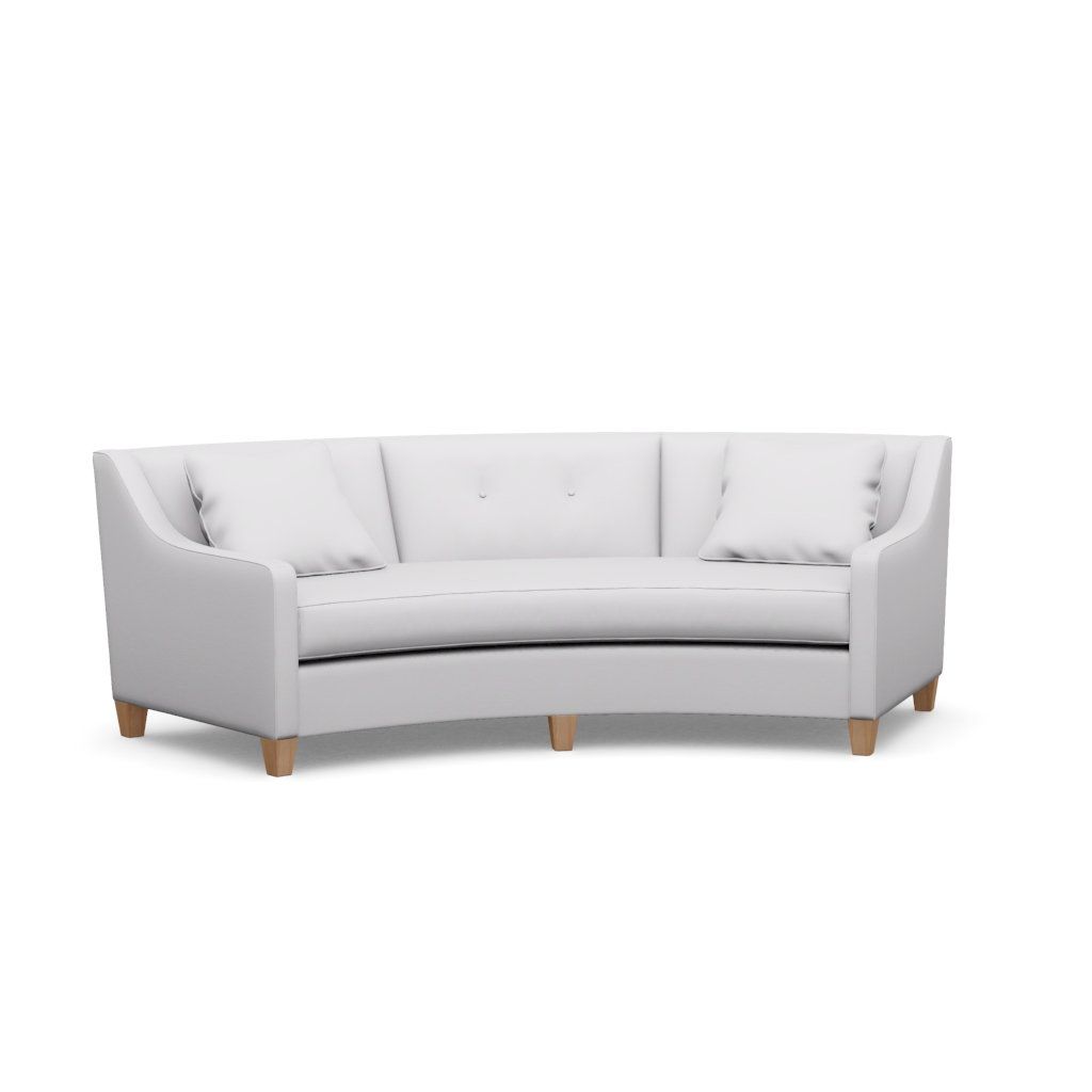 A white curved couch with wooden legs on a white background.