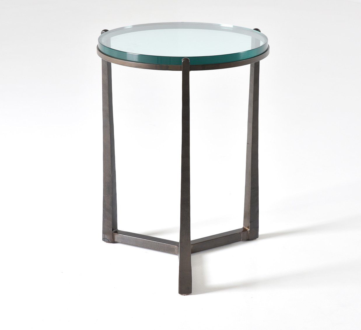 A small round table with a glass top on a white background.