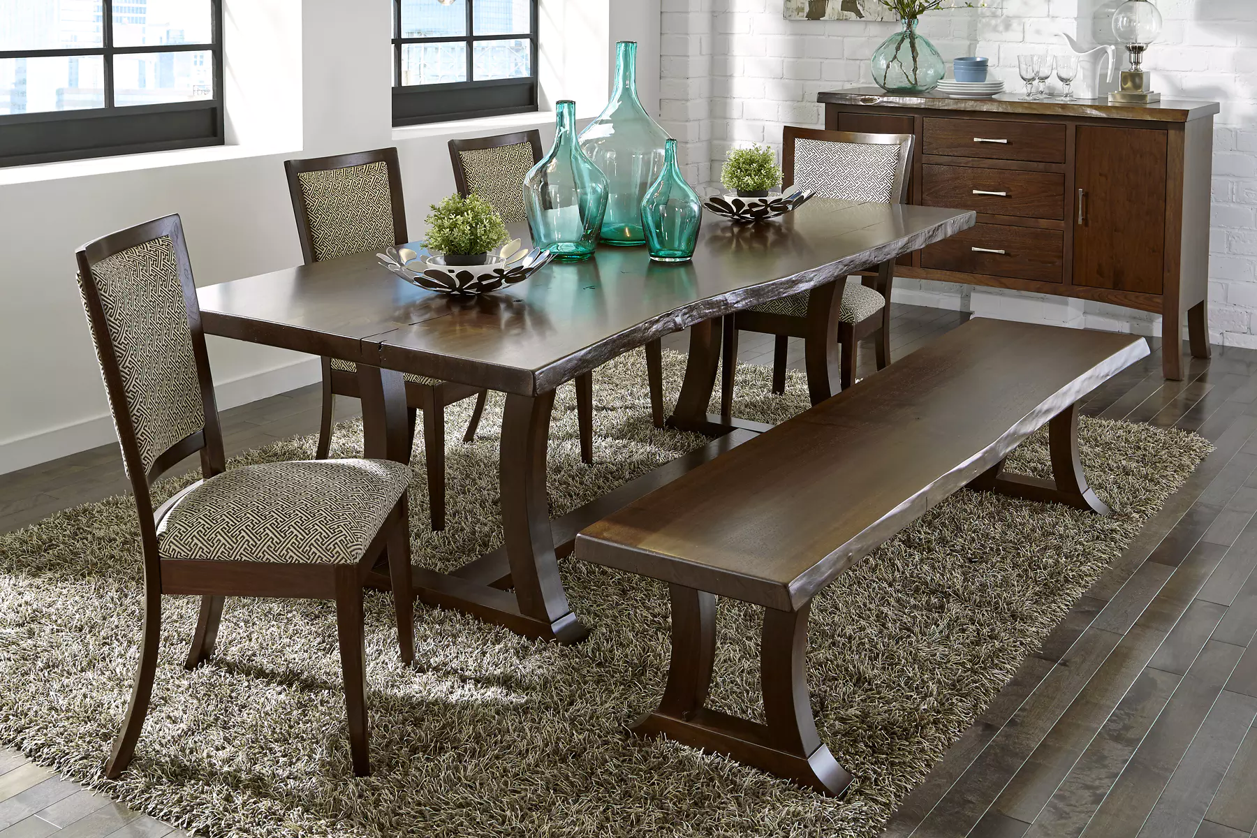 A dining room with a table and chairs and a bench
