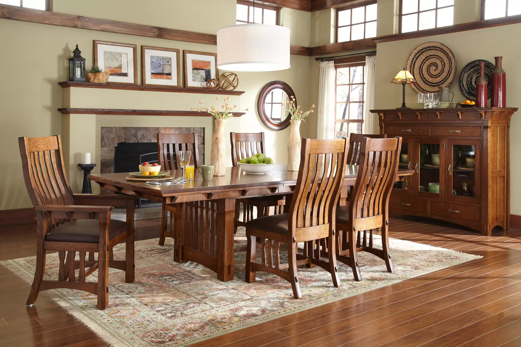 A dining room with a table and chairs and a fireplace.