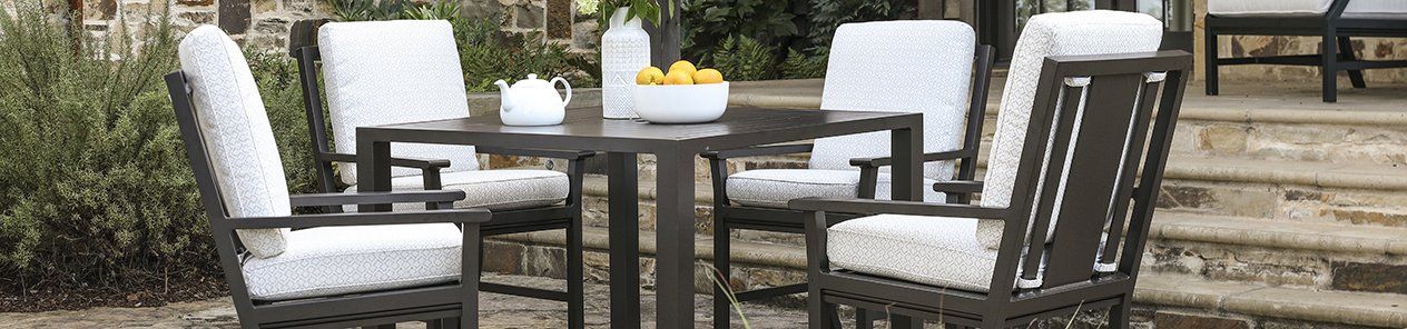 A table and chairs are sitting on a patio.