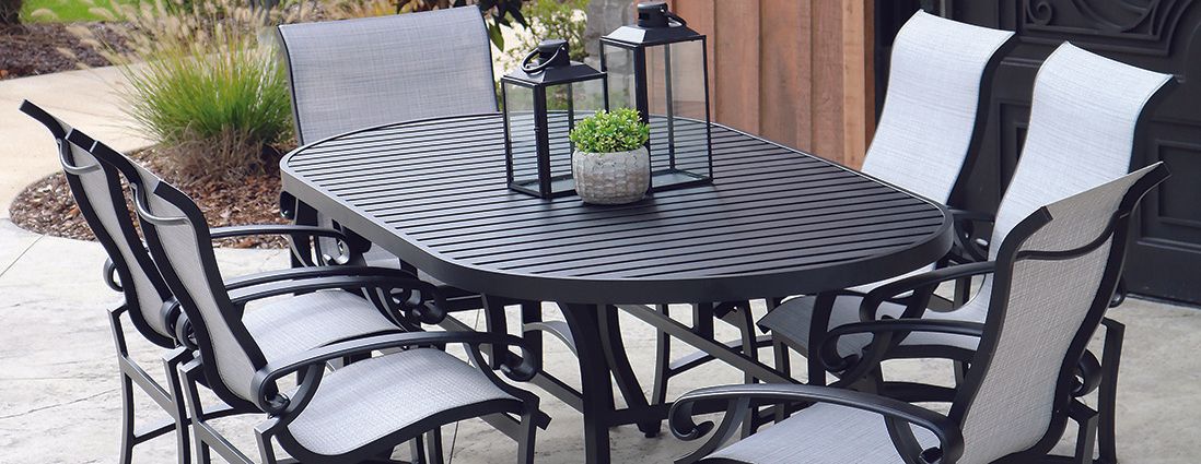A patio set with a table and chairs on a concrete patio.