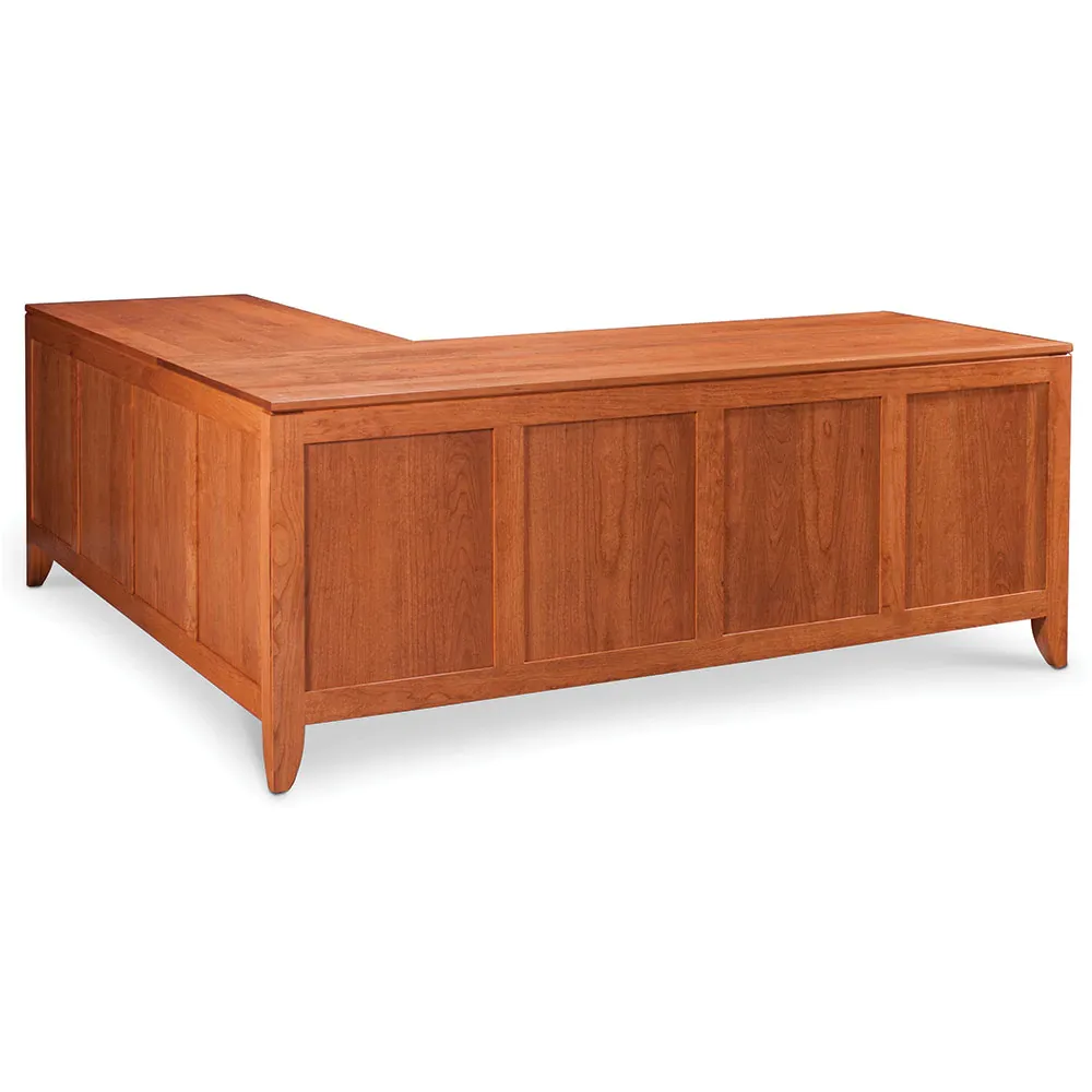 A wooden l shaped desk with a white background