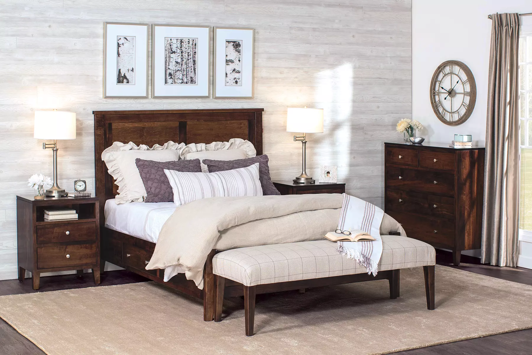 A bedroom with a bed , dresser , nightstand , and bench.
