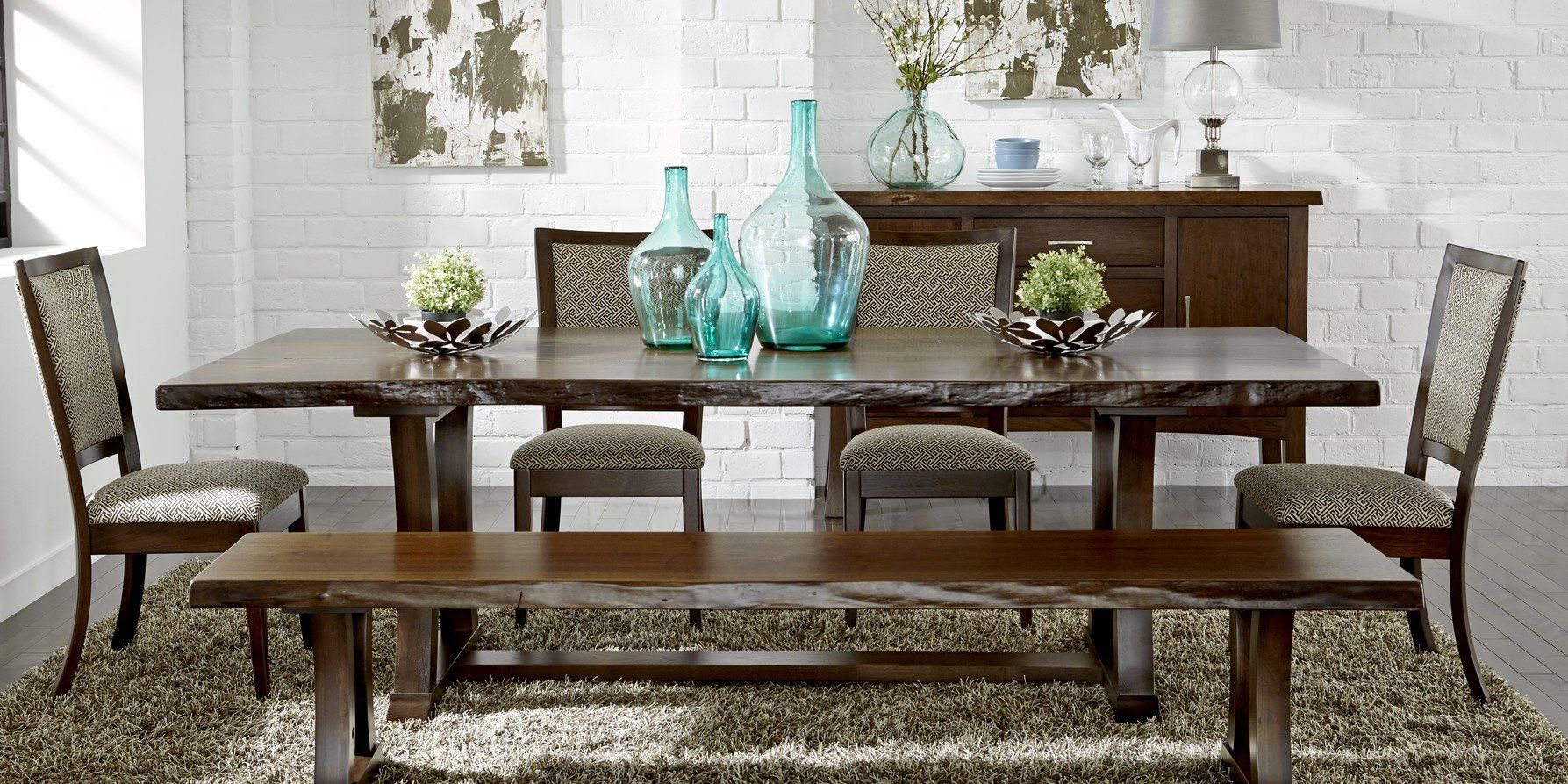 A dining room with a table and chairs and a bench