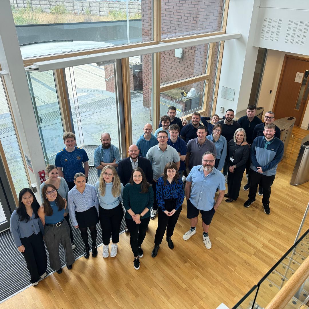 A group of people are posing for a picture in a building.