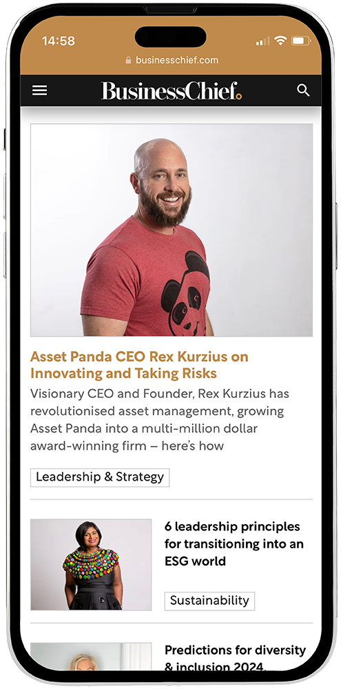 A man in a red shirt is smiling on a business chief website.