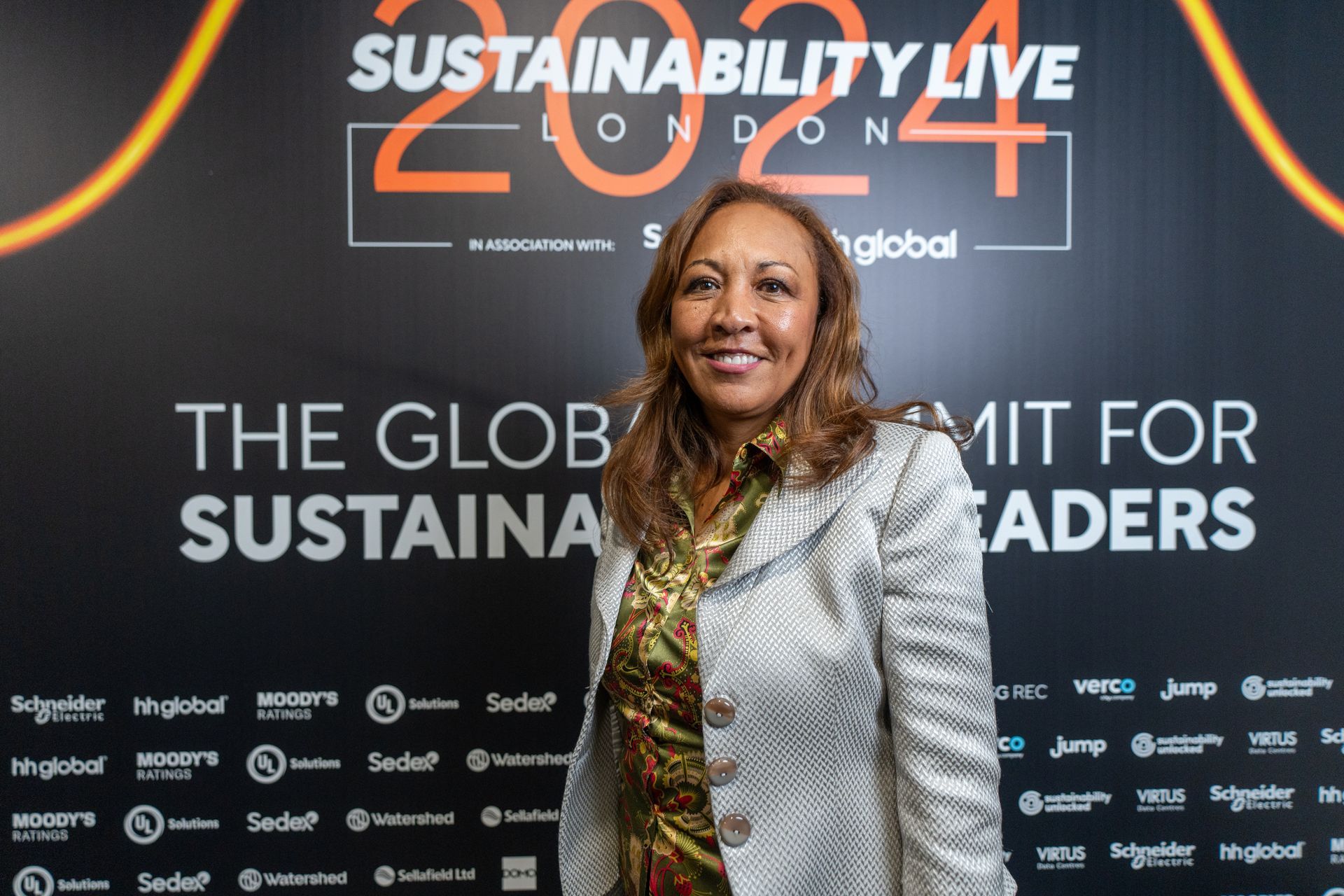 Faith Taylor standing in front of a sign that says sustainability live