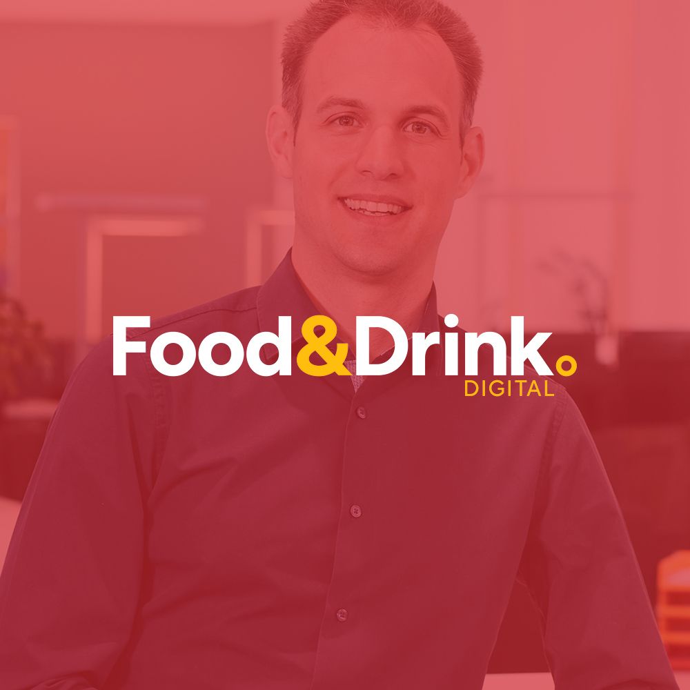 A man is smiling in front of a red background with the words food & drink digital