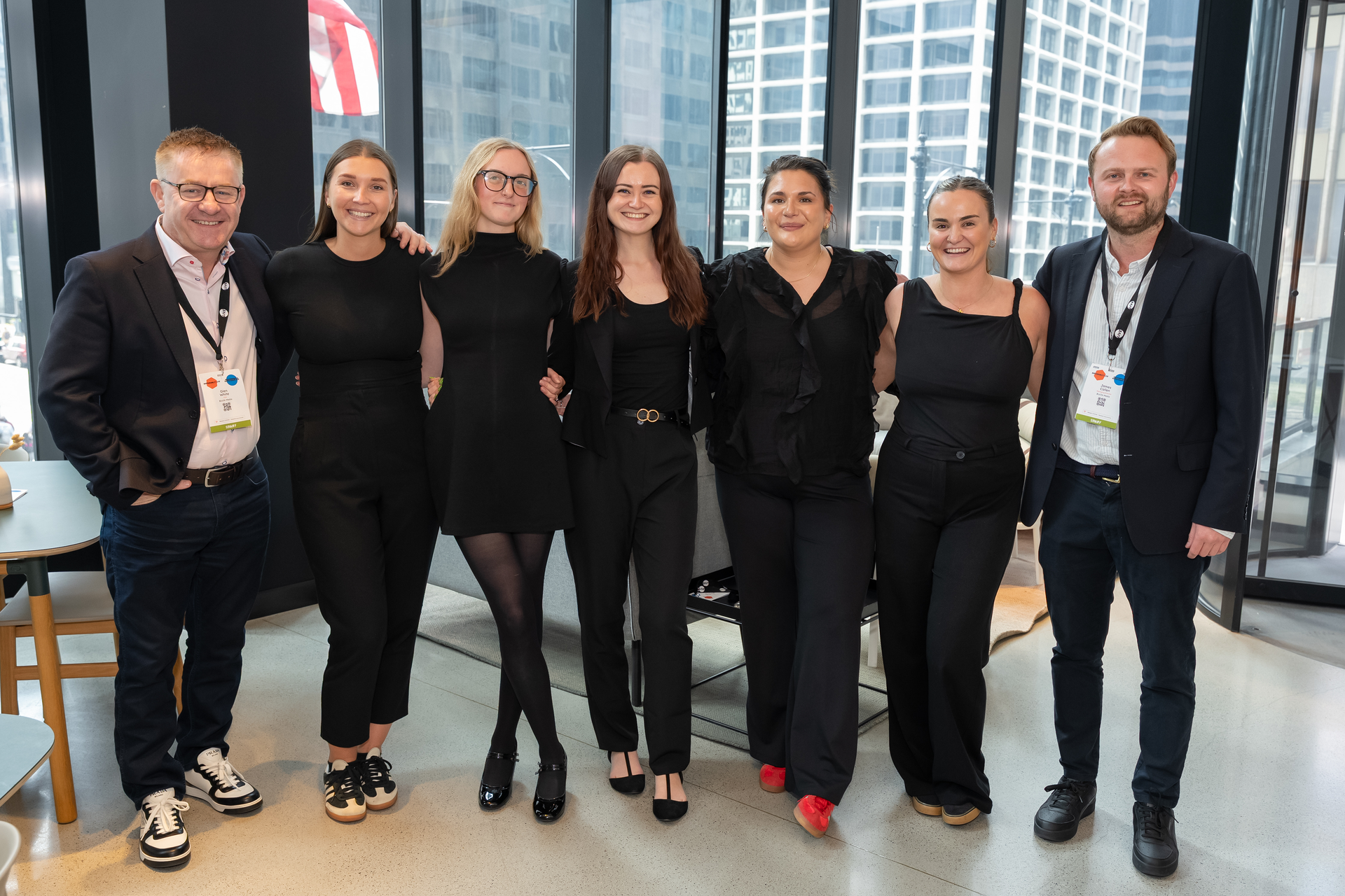 CEO Glen White and the events team in black standing next to each other at the event