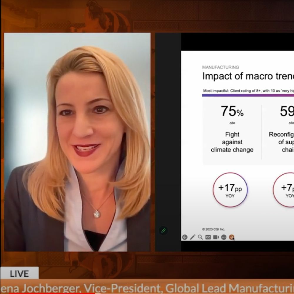 A woman is sitting in front of a screen that says impact of macro trends