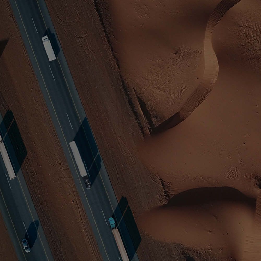 A man in a suit is talking to two other men