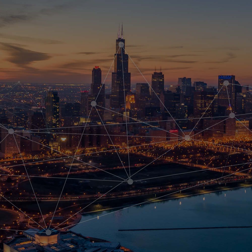 A city skyline at night with a purple background