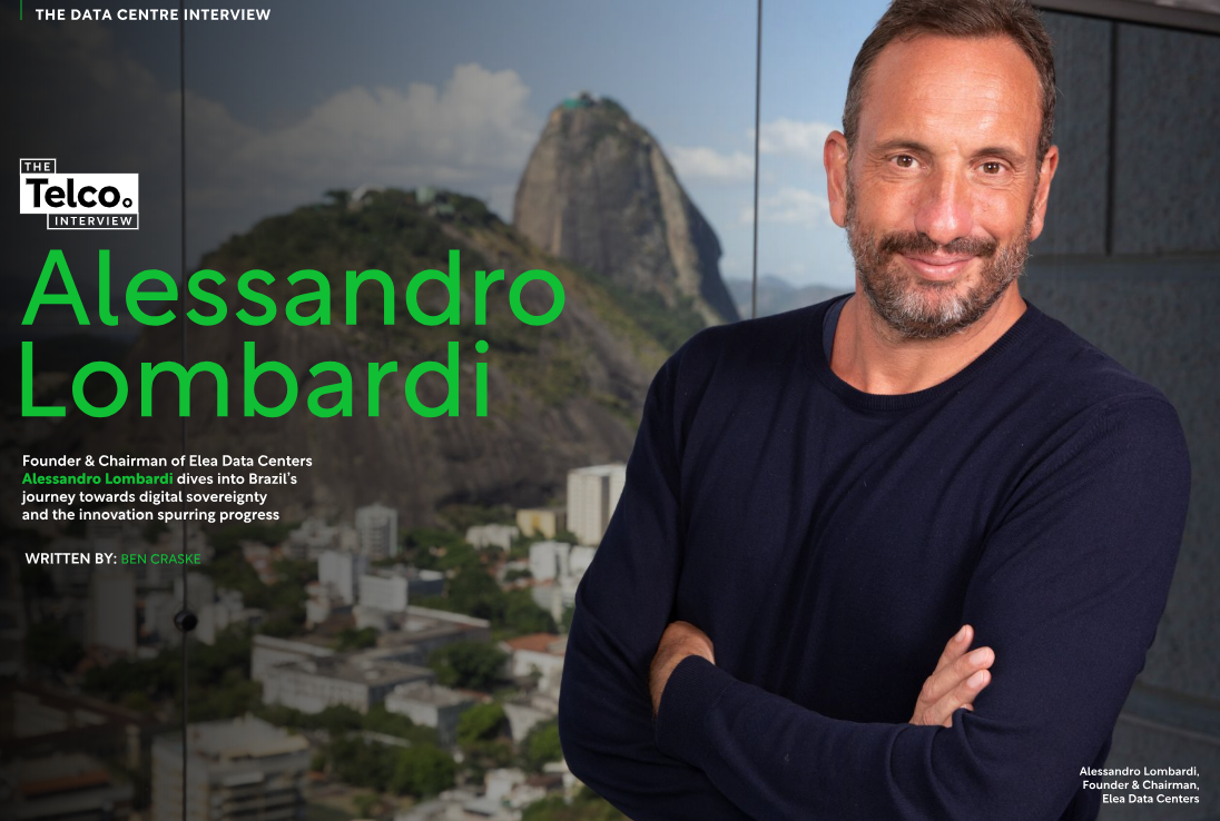 Alessandro Lombardi, arms crossed, smiles, in front of a Rio de Janeiro backdrop.