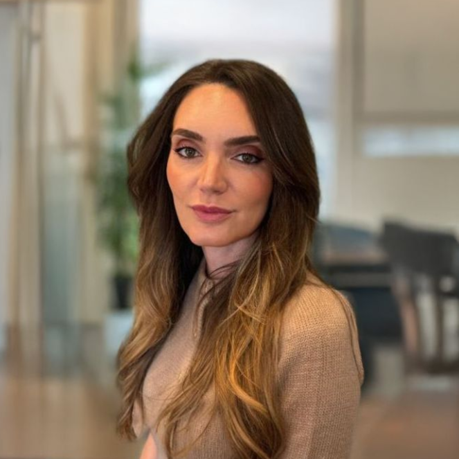 A man in a suit and tie is leaning on a railing.