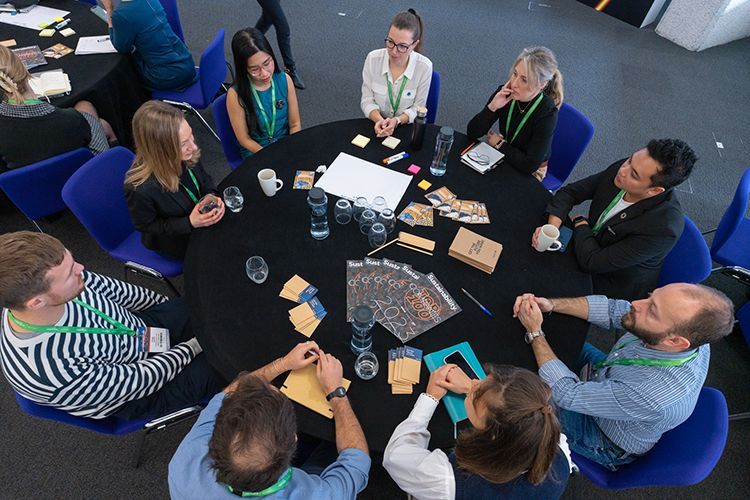 A group of people are sitting around a table.