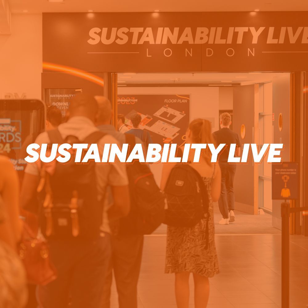 A group of people standing in front of a sign that says sustainability live