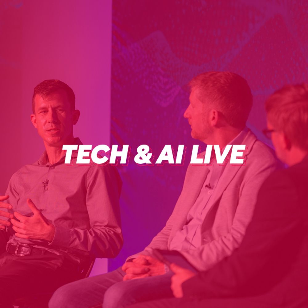 A group of men are sitting in front of a red background with the words tech & ai live on it.