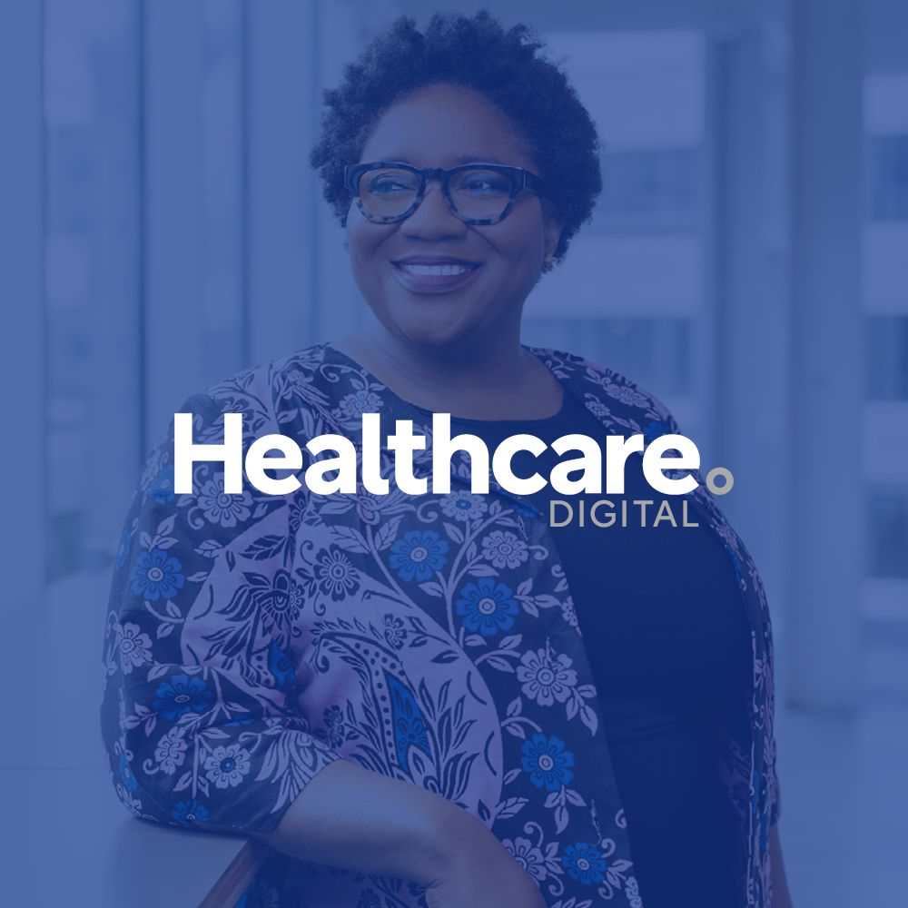 A woman wearing glasses is smiling in front of a healthcare digital logo.