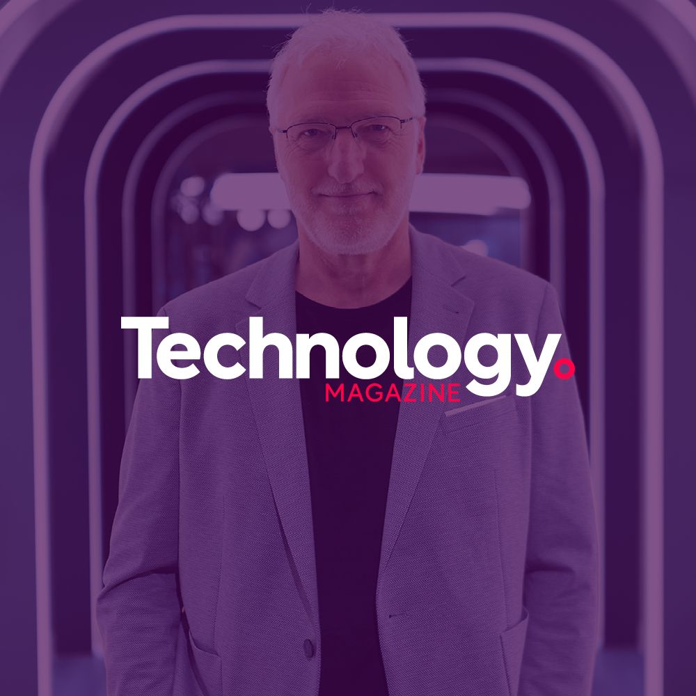 A man in a suit and glasses is on the cover of a technology magazine