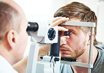 Man Getting Eyes Checked — Family Eye Care in Rochester, PA