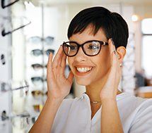 Woman Trying on Glasses — Optometry Services in Rochester, PA Woman Trying on Glasses — Optometry Services in Rochester, PA